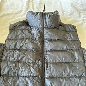 Uniqlo black ultra light weight down vest .
